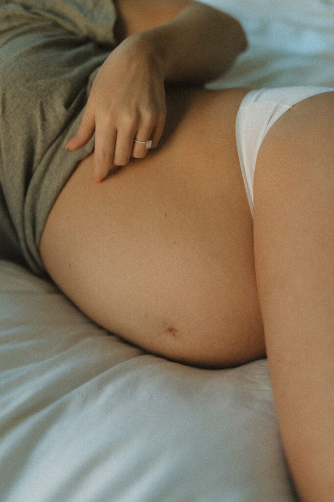 en gravid mage och en hand som smeker den